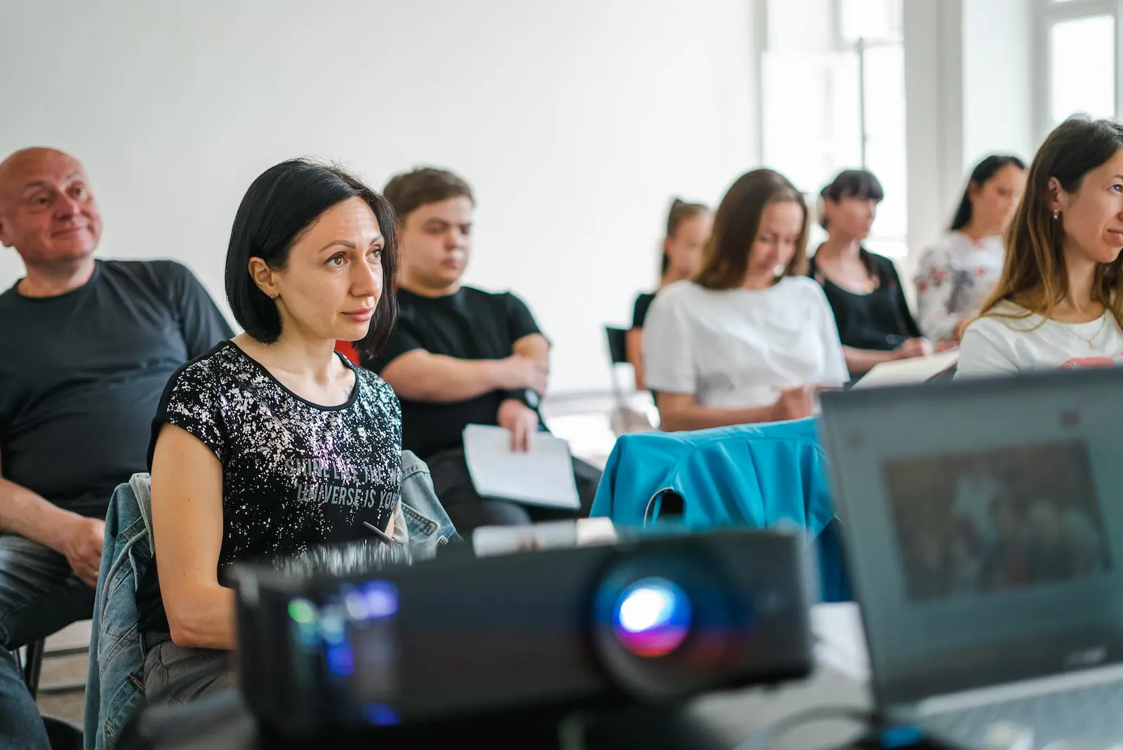 a group of people sitting at computers