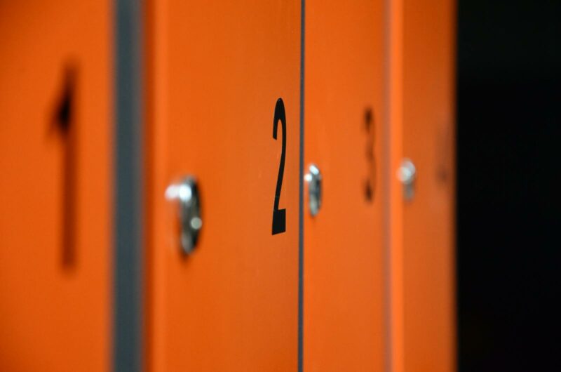 Close-up of orange lockers with numbers, focusing on locker number two.